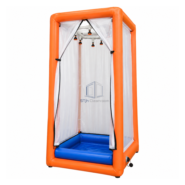 STjh compact single-person pneumatic decontamination shower with an orange frame and integral blue collection pool